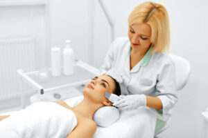 Professional therapist delivering a specialized anti-ageing facial at a luxury beauty salon Gloucester.