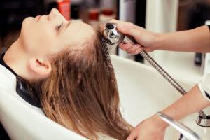Woman having head washed at hair salon Gloucester
