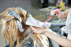 woman having hair coloured at hair salon Gloucester