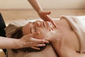 Professional therapist performing a relaxing massage Gloucester at Penelope Hair and Beauty salon.